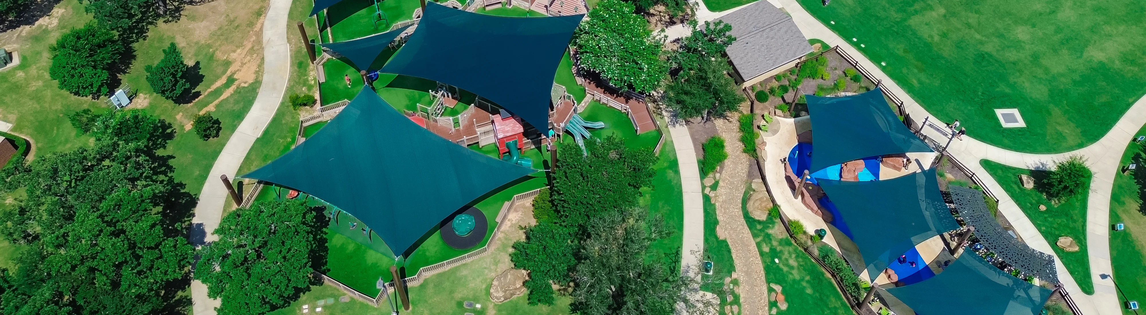 Aerial view of a landscaped community recreation area with paths and shared green spaces